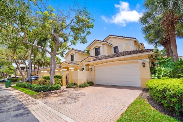 1504 Passion Vine Cir Unit 23-4, Weston, FL 33326 - mediterranean / spanish house featuring stucco siding, a tiled roof, decorative driveway, and fence
