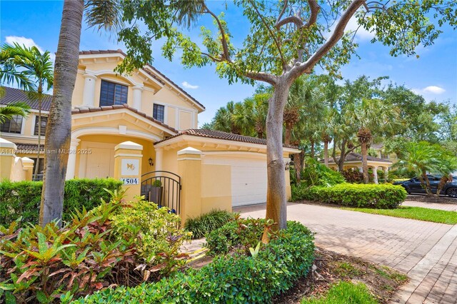 1504 Passion Vine Cir Unit 23-4, Weston, FL 33326 - mediterranean / spanish home with decorative driveway, an attached garage, and stucco siding