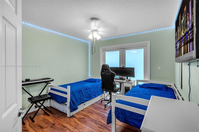 1708 NW 126th Dr, Coral Springs, FL 33071 - bedroom featuring wood finished floors, a textured ceiling, an office area, and a ceiling fan