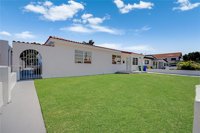 6830 SW 1st St, Miami, FL 33144 - mediterranean / spanish house with a tile roof, stucco siding, and a front yard