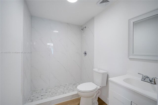 6830 SW 1st St, Miami, FL 33144 - full bathroom with a marble finish shower, toilet, vanity, and wood finished floors