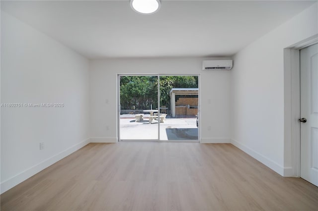 6830 SW 1st St, Miami, FL 33144 - spare room with wood finished floors, an AC wall unit, and baseboards