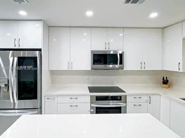 6355 SW 138th Path Unit 6355, Miami, FL 33183 - kitchen featuring appliances with stainless steel finishes, modern cabinets, white cabinetry, light countertops, and recessed lighting