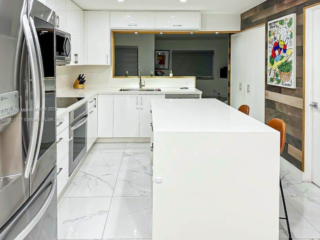 6355 SW 138th Path Unit 6355, Miami, FL 33183 - kitchen featuring stainless steel appliances, a sink, light marble finish flooring, white cabinetry, and recessed lighting