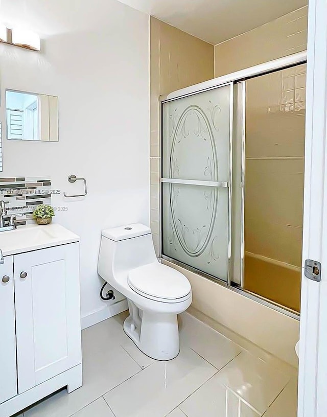 6355 SW 138th Path Unit 6355, Miami, FL 33183 - full bathroom featuring combined bath / shower with glass door, tile patterned flooring, toilet, and vanity