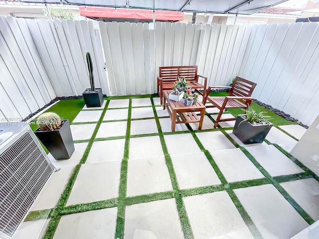 6355 SW 138th Path Unit 6355, Miami, FL 33183 - view of patio featuring a fenced backyard and central air condition unit