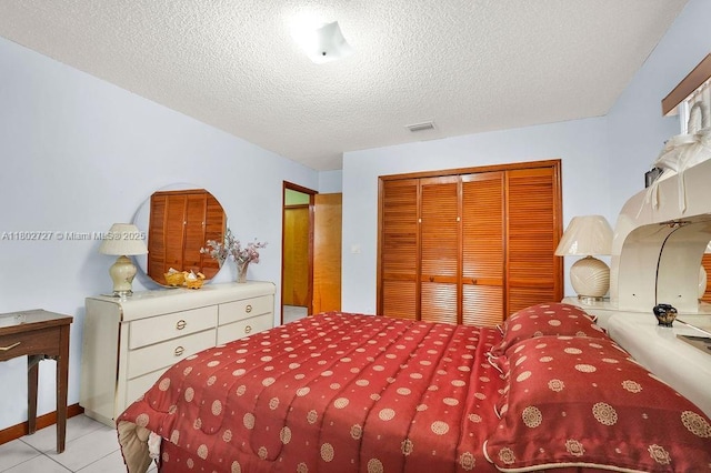 330 SW 133rd Ct, Miami, FL 33184 - bedroom featuring a closet, a textured ceiling, and light tile patterned floors