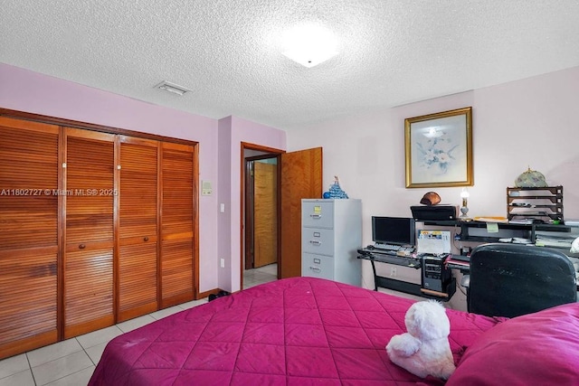 330 SW 133rd Ct, Miami, FL 33184 - bedroom featuring a closet, light tile patterned floors, and a textured ceiling