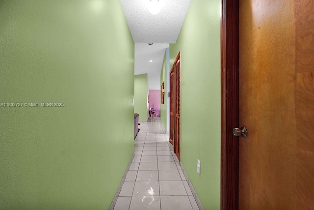 330 SW 133rd Ct, Miami, FL 33184 - corridor featuring light tile patterned floors and a textured ceiling