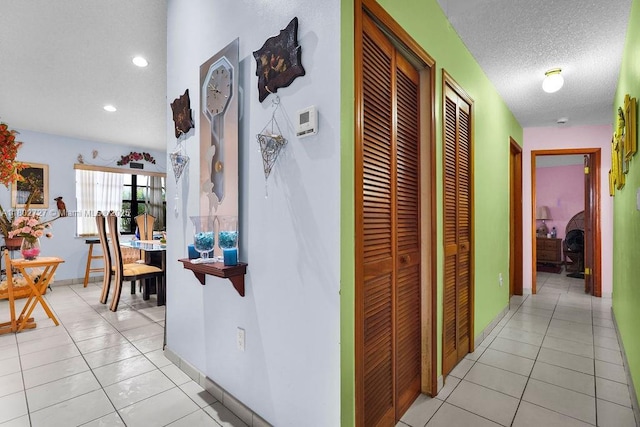 330 SW 133rd Ct, Miami, FL 33184 - hallway featuring light tile patterned floors, recessed lighting, a textured ceiling, and baseboards