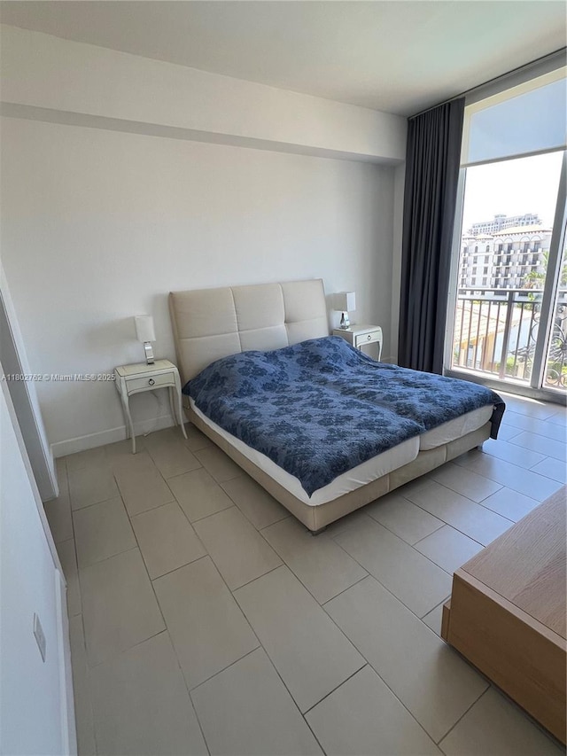 1607 Ponce De Leon Blvd Unit 8B, Coral Gables, FL 33134 - bedroom with floor to ceiling windows and light tile patterned flooring