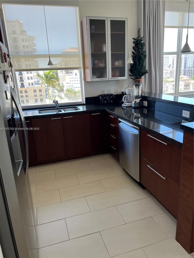 1607 Ponce De Leon Blvd Unit 8B, Coral Gables, FL 33134 - kitchen featuring stainless steel appliances, a sink, modern cabinets, a view of city, and glass insert cabinets