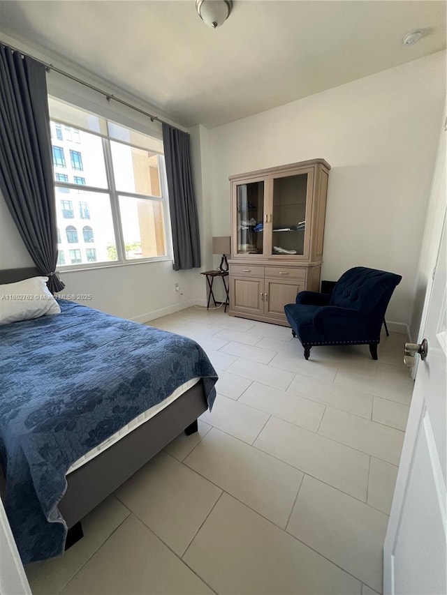 1607 Ponce De Leon Blvd Unit 8B, Coral Gables, FL 33134 - bedroom featuring baseboards and light tile patterned floors