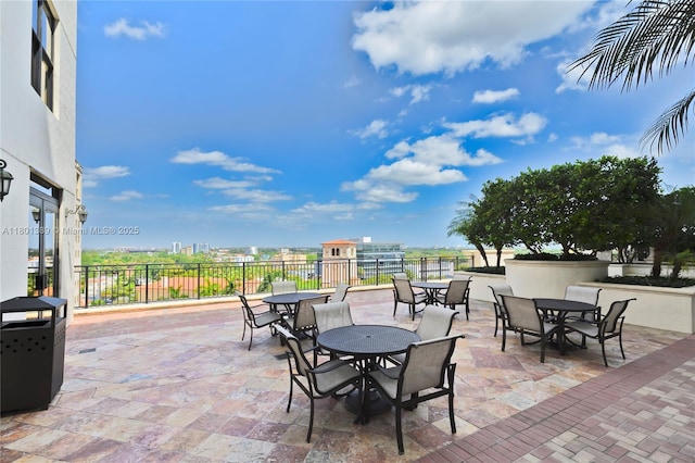 view of patio featuring outdoor dining area and fence
