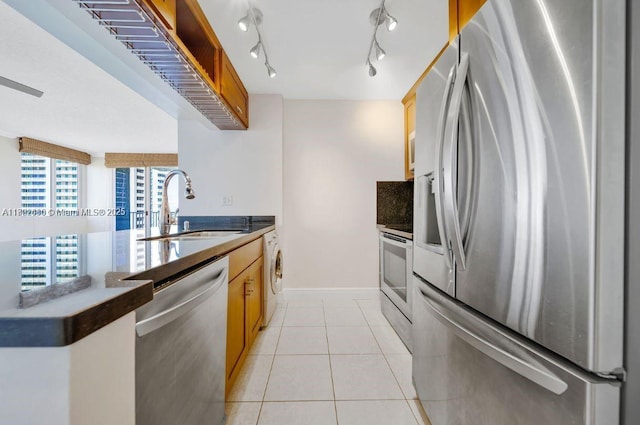 800 N Miami Ave Unit E-1709, Miami, FL 33136 - kitchen featuring appliances with stainless steel finishes, a sink, washer / clothes dryer, dark countertops, and a peninsula