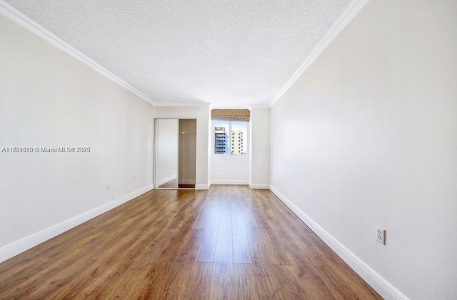 800 N Miami Ave Unit E-1709, Miami, FL 33136 - spare room with a textured ceiling, wood finished floors, ornamental molding, and baseboards