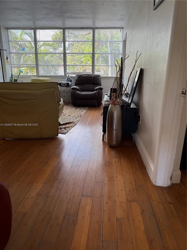 2175 NE 170th St Unit 202, North Miami Beach, FL 33162 - living room featuring hardwood / wood-style flooring and baseboards