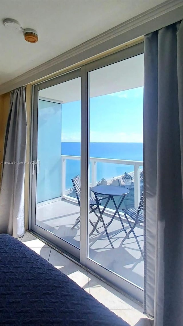 19201 Collins Ave Unit 1105, Sunny Isles Beach, FL 33160 - doorway to outside with a water view and crown molding