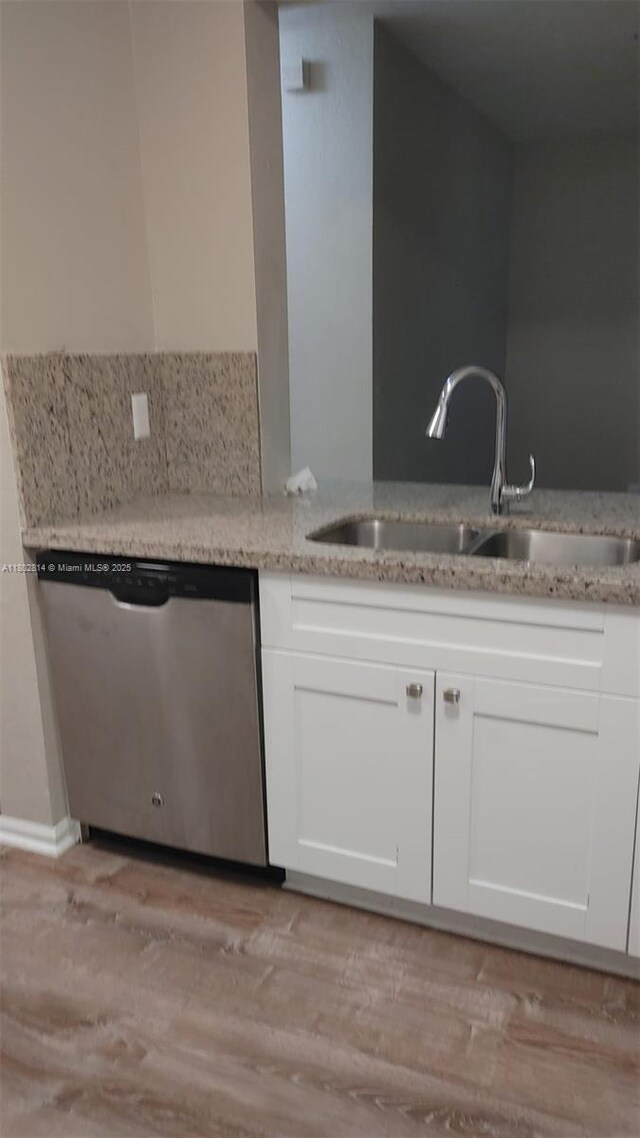 1165 Golden Lakes Blvd Unit 1221, West Palm Beach, FL 33411 - kitchen featuring stainless steel dishwasher, light stone countertops, white cabinetry, and light wood-style floors