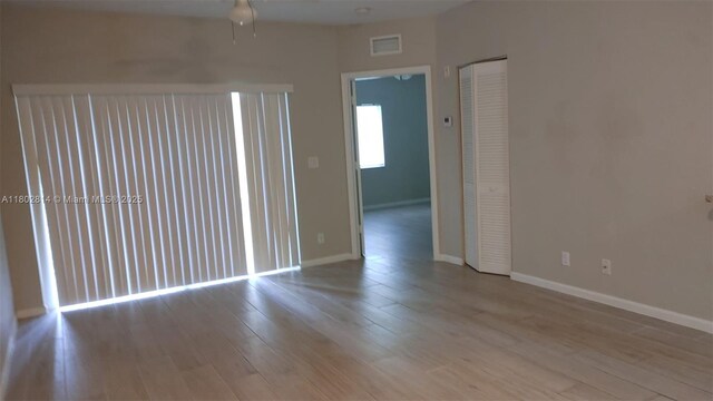 1165 Golden Lakes Blvd Unit 1221, West Palm Beach, FL 33411 - spare room featuring a ceiling fan and wood finished floors