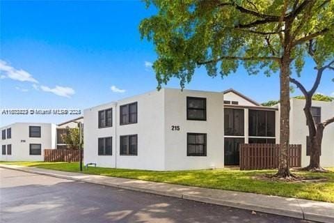 212 Lake Pointe Dr Unit 210, Oakland Park, FL 33309 - view of front of property featuring stucco siding and a sunroom