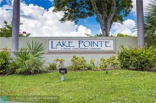 212 Lake Pointe Dr Unit 210, Oakland Park, FL 33309 - community / neighborhood sign featuring a lawn