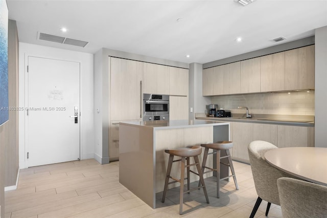 4010 S Ocean Dr Unit T3607, Hollywood, FL 33019 - kitchen featuring modern cabinets, light brown cabinets, a kitchen island, and recessed lighting
