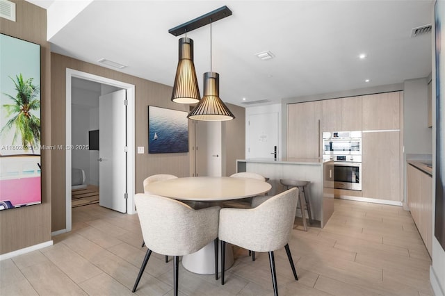 4010 S Ocean Dr Unit T3607, Hollywood, FL 33019 - dining space featuring wood walls, recessed lighting, and light wood-style flooring