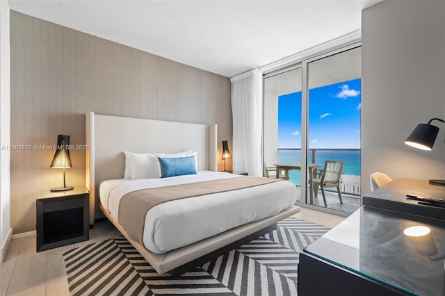 4010 S Ocean Dr Unit T3607, Hollywood, FL 33019 - bedroom with floor to ceiling windows, access to exterior, a water view, wallpapered walls, and light wood-style flooring