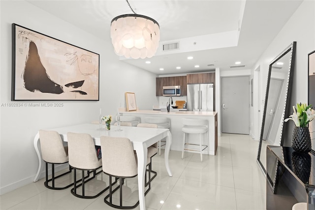 488 NE 18th St Unit 704, Miami, FL 33132 - dining space featuring recessed lighting, light tile patterned floors, baseboards, and a chandelier