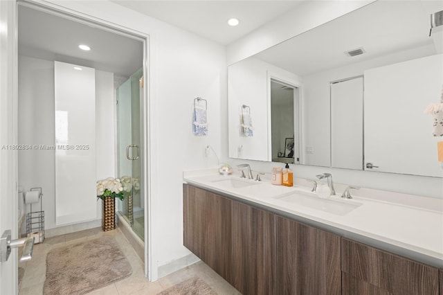 488 NE 18th St Unit 704, Miami, FL 33132 - bathroom with a shower stall, recessed lighting, double vanity, and tile patterned floors