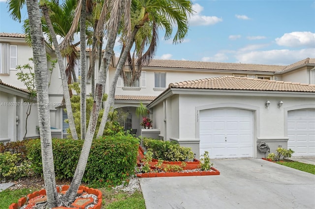 7377 SW 162nd Path, Miami, FL 33193 - view of front of property with concrete driveway, stucco siding, a tiled roof, and an attached garage