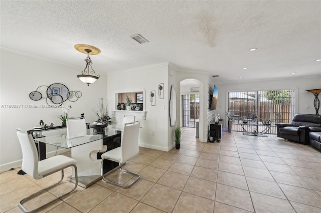 7377 SW 162nd Path, Miami, FL 33193 - dining space with light tile patterned flooring, ornamental molding, arched walkways, baseboards, and a textured ceiling