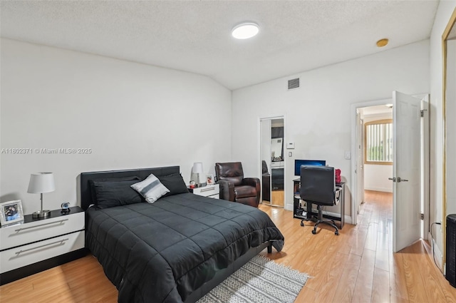 7377 SW 162nd Path, Miami, FL 33193 - bedroom featuring lofted ceiling, light wood-style flooring, a textured ceiling, and a desk