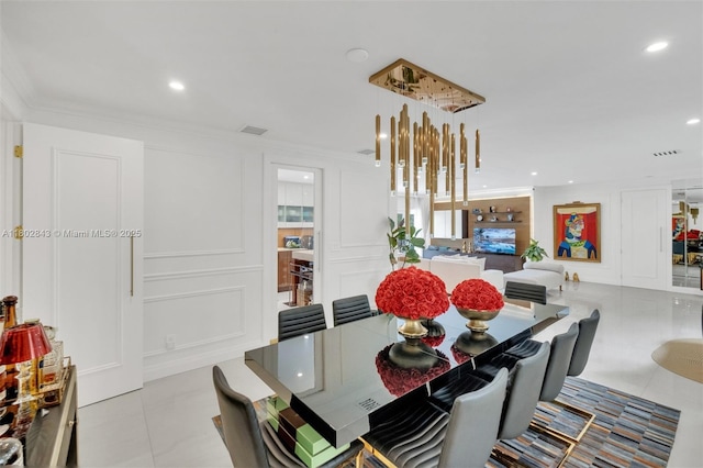 726 NE 17th Way, Fort Lauderdale, FL 33304 - dining room featuring tile patterned floors, a decorative wall, recessed lighting, and ornamental molding
