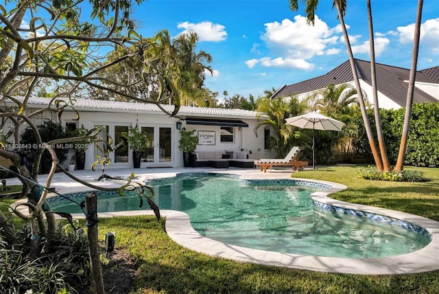 726 NE 17th Way, Fort Lauderdale, FL 33304 - outdoor pool featuring french doors, an outdoor hangout area, a patio, and a lawn