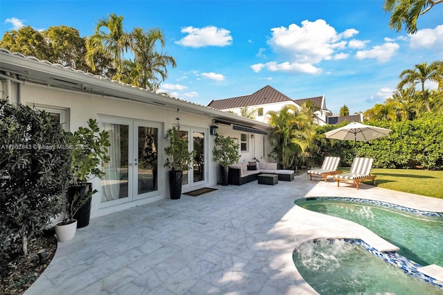 726 NE 17th Way, Fort Lauderdale, FL 33304 - back of house with french doors, stucco siding, a patio, an outdoor pool, and an outdoor hangout area