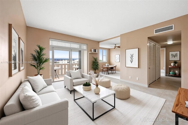 4350 Hillcrest Dr Unit 1016, Hollywood, FL 33021 - living area with light tile patterned floors, baseboards, and ceiling fan