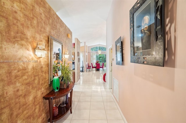 hallway with light tile patterned floors and baseboards