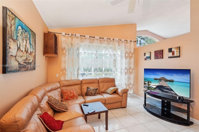 living room featuring lofted ceiling, tile patterned flooring, and ceiling fan