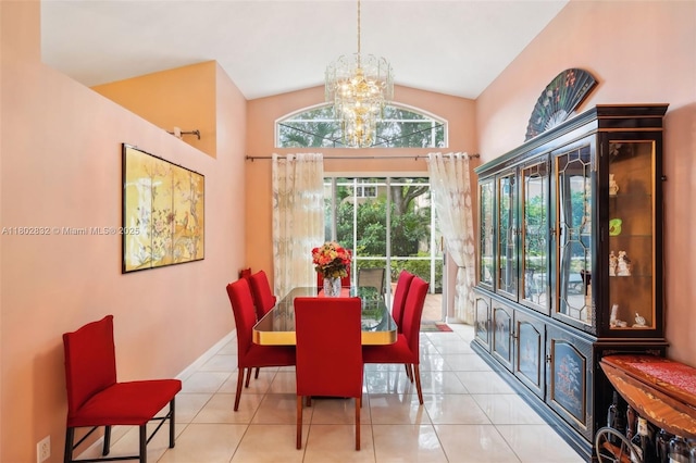 tiled dining room featuring a chandelier, vaulted ceiling, and baseboards