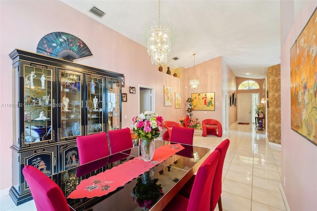 tiled dining room with a chandelier and baseboards