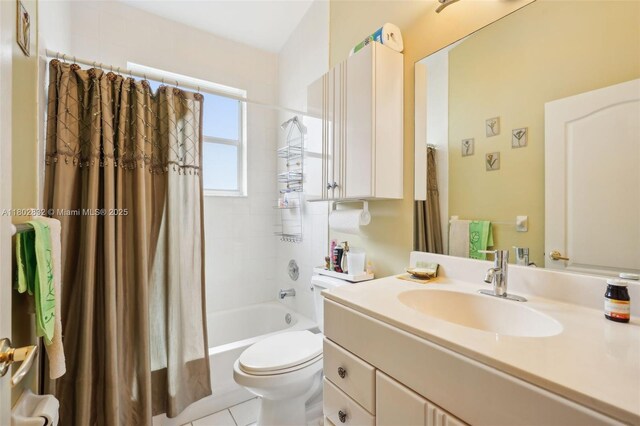 bathroom featuring toilet, shower / bathtub combination with curtain, vanity, and tile patterned floors