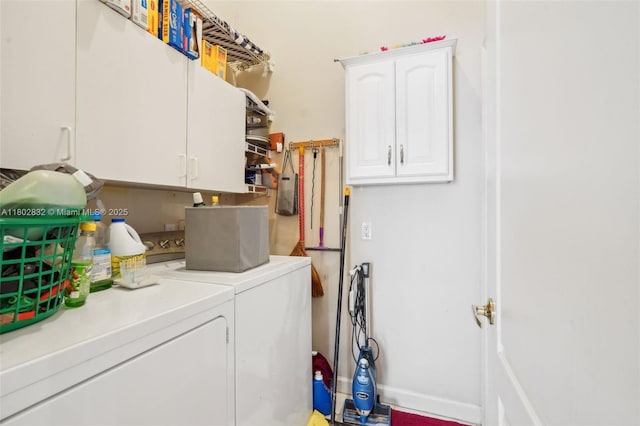 washroom with washer and dryer and cabinet space