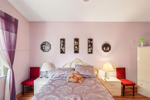 bedroom with wood finished floors