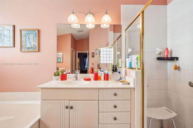 ensuite bathroom with a stall shower, vanity, and a bath