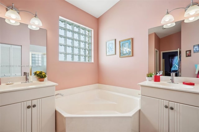 bathroom with two vanities, a bath, and a stall shower
