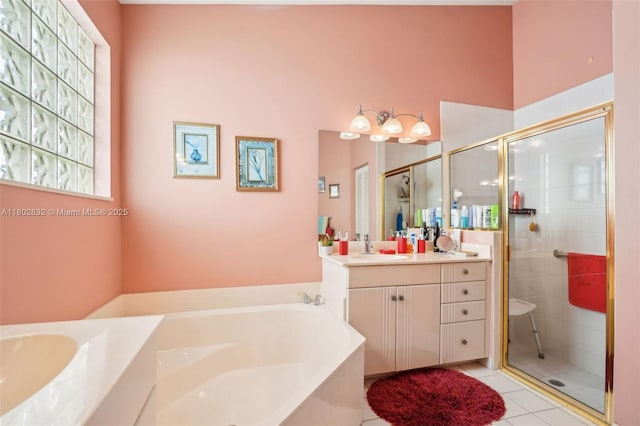 full bathroom featuring a stall shower, a garden tub, vanity, and tile patterned floors