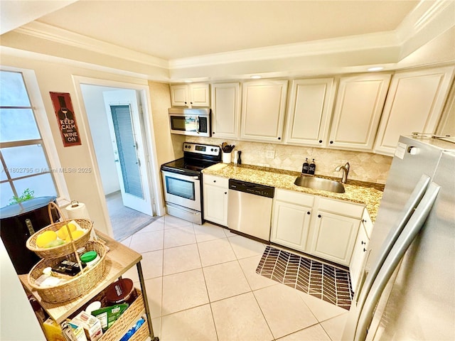 3051 S Palm Aire Dr Unit 203, Pompano Beach, FL 33069 - kitchen featuring stainless steel appliances, a sink, backsplash, ornamental molding, and light tile patterned flooring