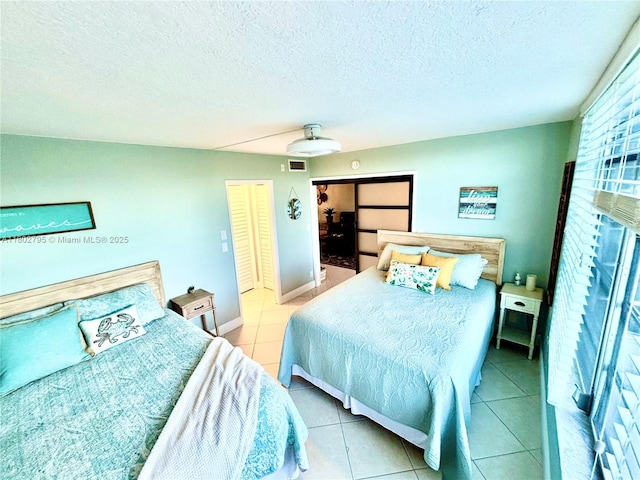 3051 S Palm Aire Dr Unit 203, Pompano Beach, FL 33069 - bedroom with tile patterned floors, a ceiling fan, and a textured ceiling